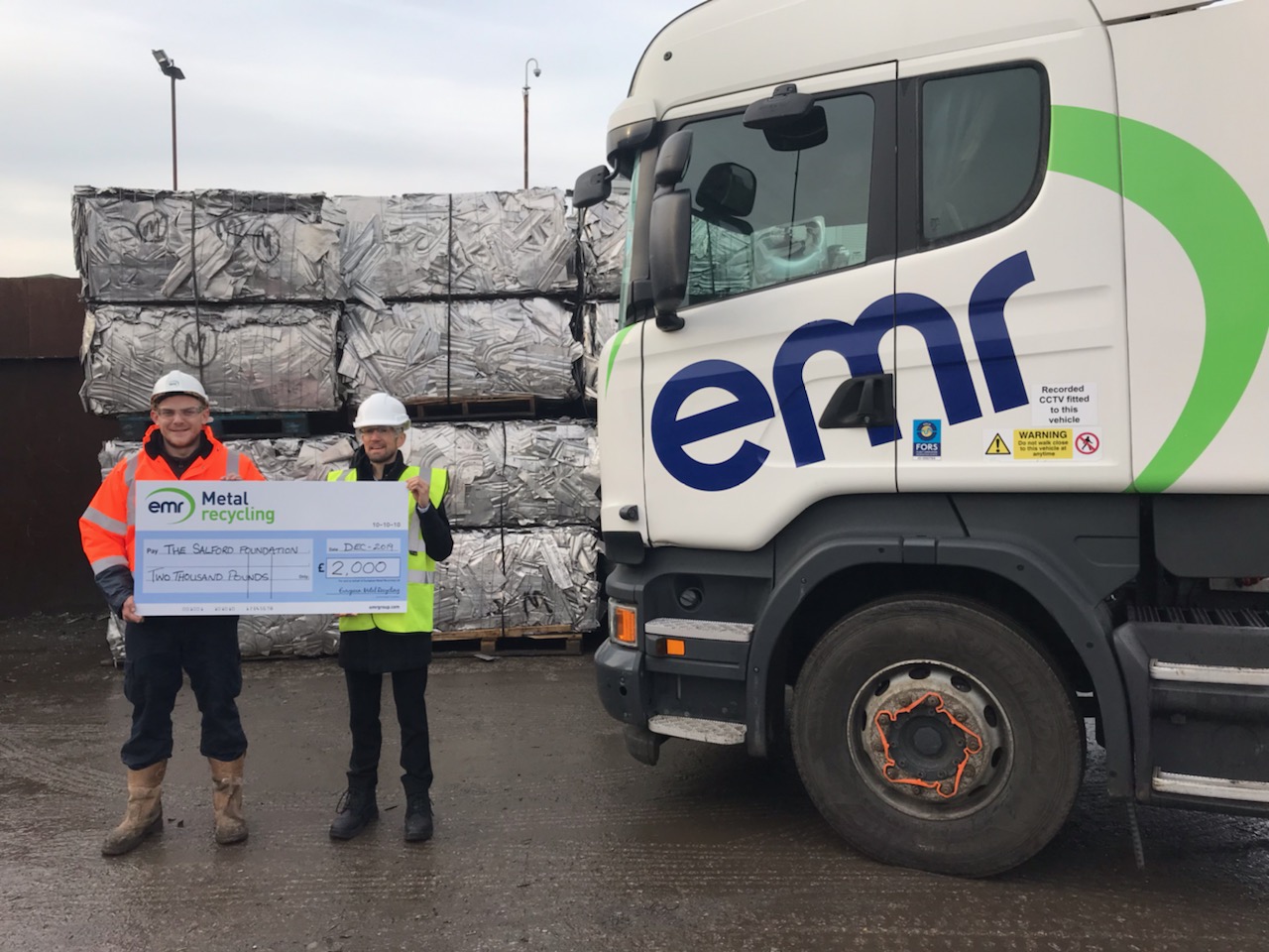 EMR Salford Site Manager, Simon Marsden presents cheque to Phil East from The Salford Foundation